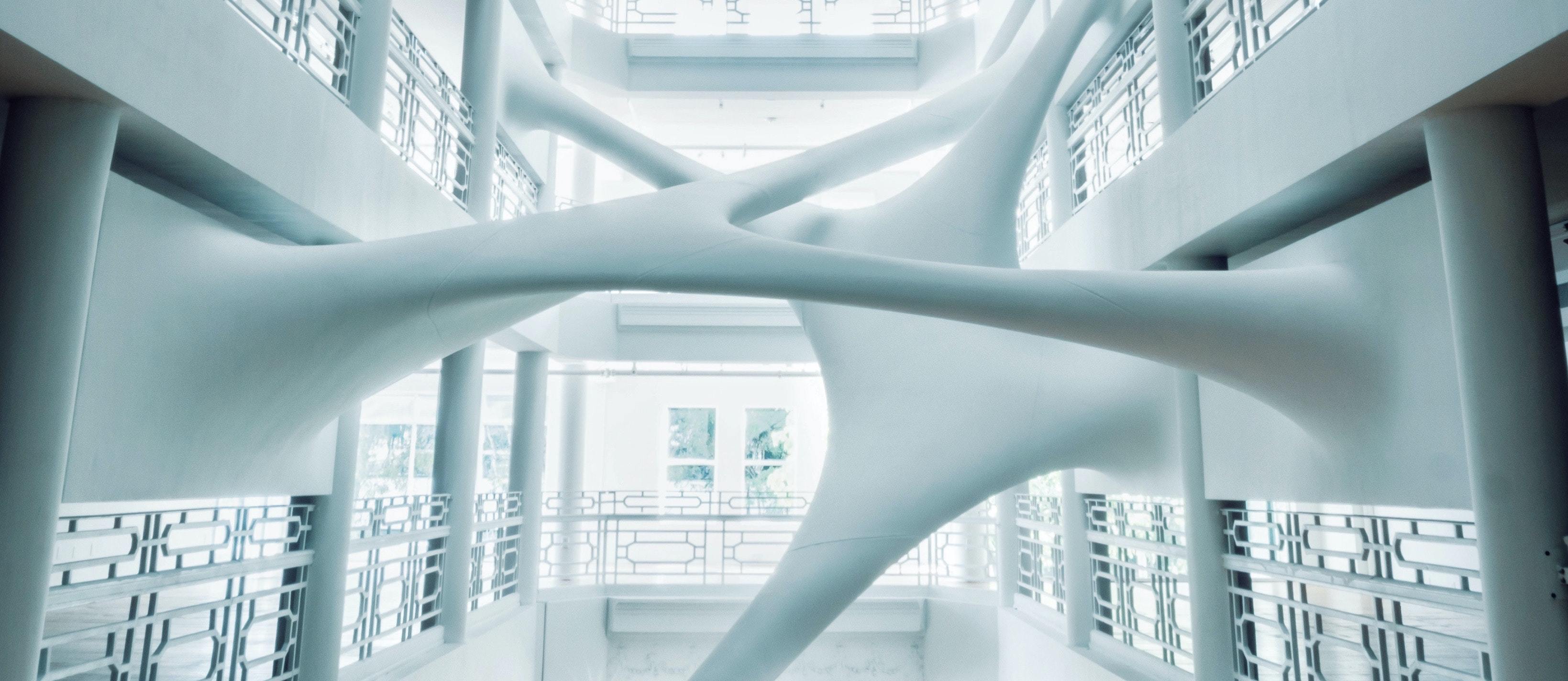 Modern architectural interior with abstract, interconnected structures, representing a unified approach to retail solutions. This image symbolizes the seamless integration of services for the future of retail.